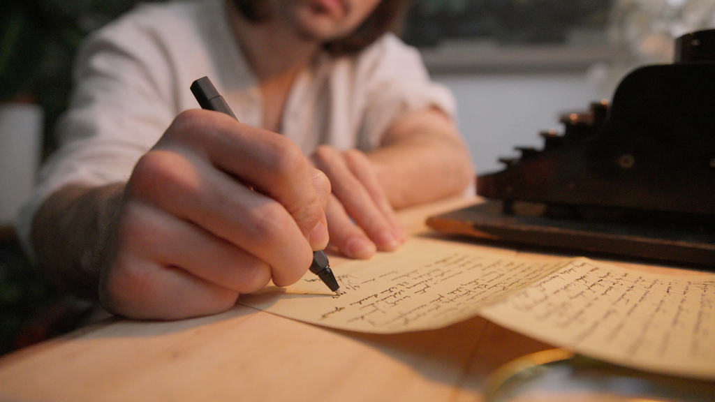 Woman writing on Paper in Leather Journal Sovereign Gear